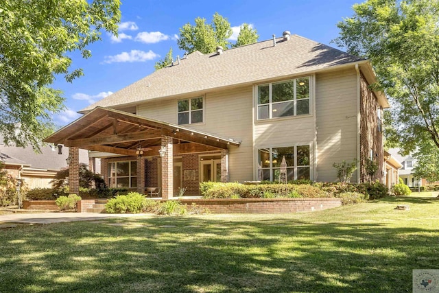 back of property featuring ceiling fan, a patio area, and a yard