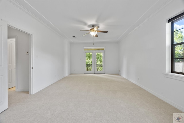 unfurnished room with ceiling fan, light carpet, ornamental molding, and french doors