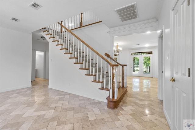 stairway with french doors, crown molding, and a chandelier