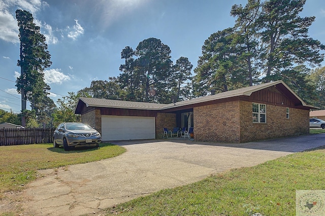 ranch-style home featuring a garage and a front yard