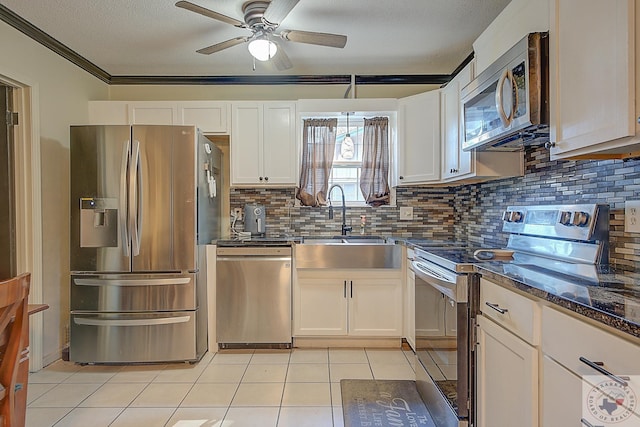 kitchen with white cabinets, stainless steel appliances, and light tile patterned floors