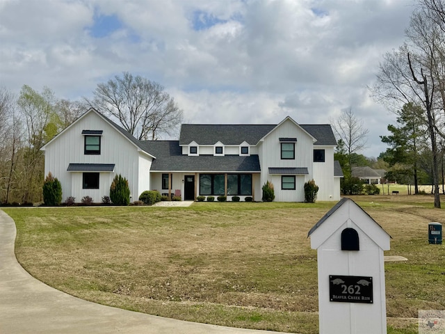 modern farmhouse with board and batten siding, roof with shingles, and a front lawn