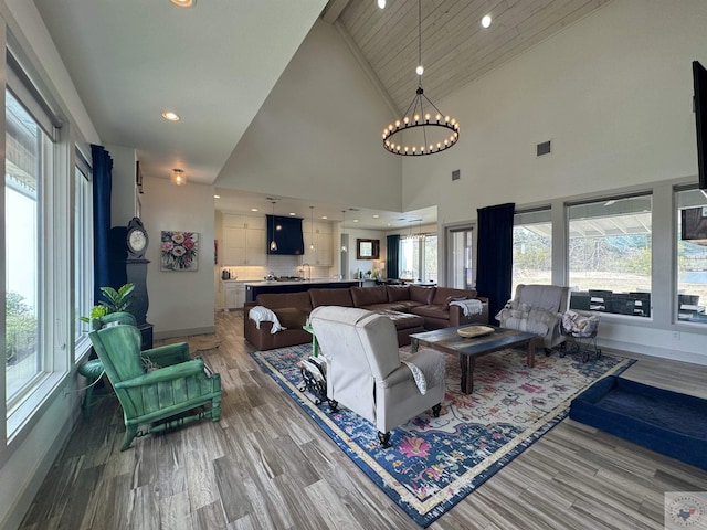 living area featuring light wood-style flooring, a notable chandelier, recessed lighting, and visible vents