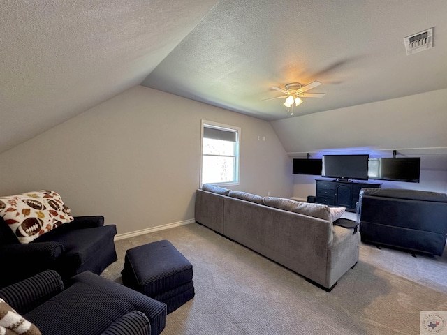 living area with visible vents, baseboards, ceiling fan, vaulted ceiling, and light carpet