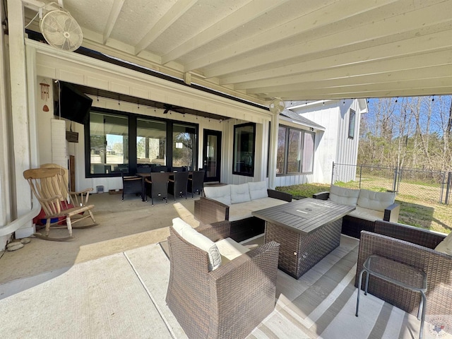 view of patio / terrace featuring an outdoor living space, outdoor dining area, and fence