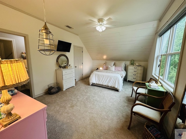 carpeted bedroom featuring a ceiling fan, lofted ceiling, baseboards, and visible vents