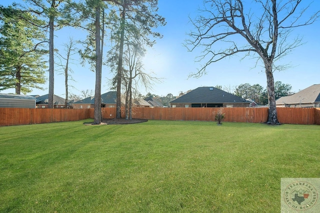 view of yard with a fenced backyard