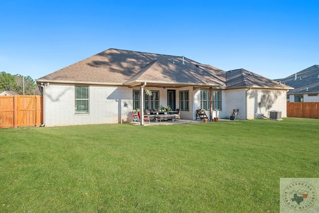 rear view of house with a patio area, fence, cooling unit, and brick siding