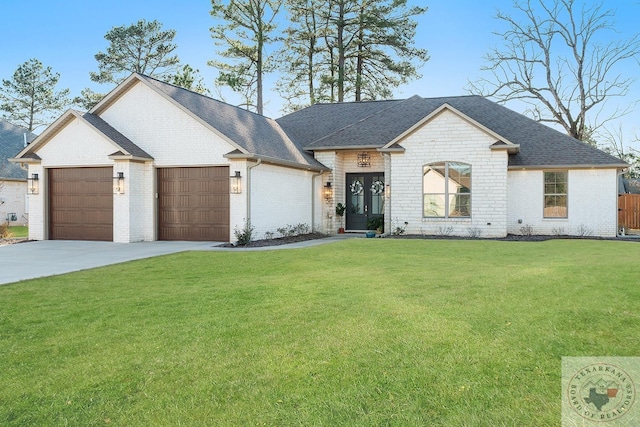 view of front facade featuring concrete driveway, roof with shingles, an attached garage, a front yard, and brick siding