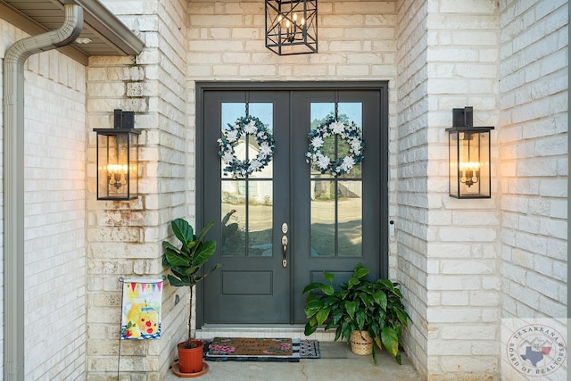 doorway to property with stone siding and french doors