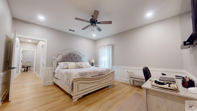 bedroom with light wood-type flooring, wainscoting, a ceiling fan, and recessed lighting