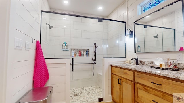 bathroom featuring an enclosed shower and vanity