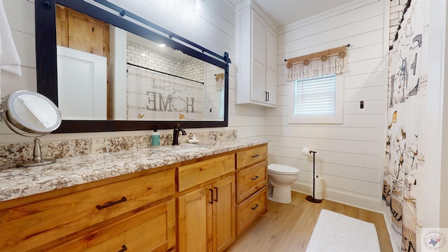 bathroom featuring vanity, walk in shower, wooden walls, and wood-type flooring