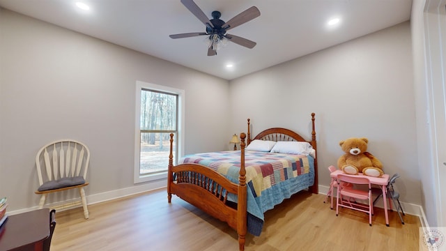 bedroom with ceiling fan and light hardwood / wood-style flooring