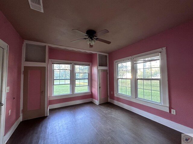 unfurnished room with ceiling fan and dark hardwood / wood-style flooring