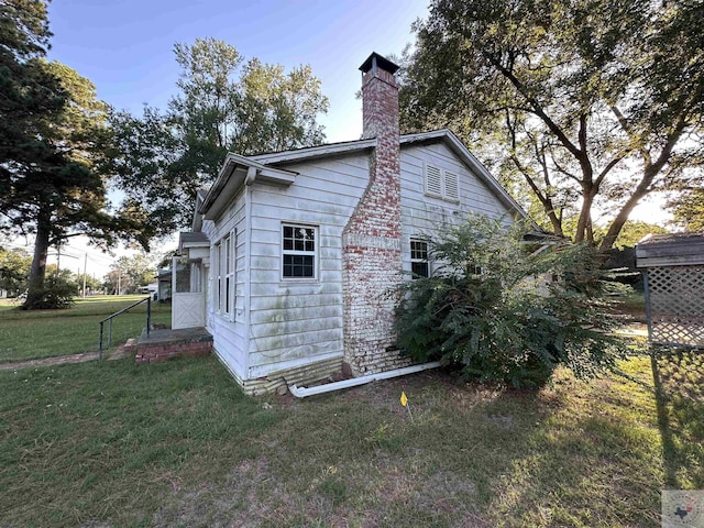 view of side of property with a lawn