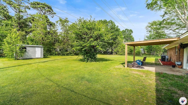 view of yard with an outdoor structure, a storage unit, and a patio area