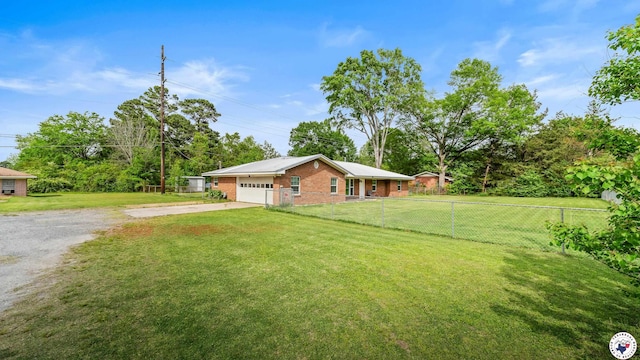 exterior space featuring an attached garage, driveway, a front lawn, and fence