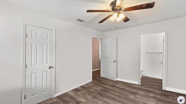 2401 E E Ave B, Hooks, TX 75561 - unfurnished bedroom with wood finished floors, baseboards, a ceiling fan, and ensuite bathroom