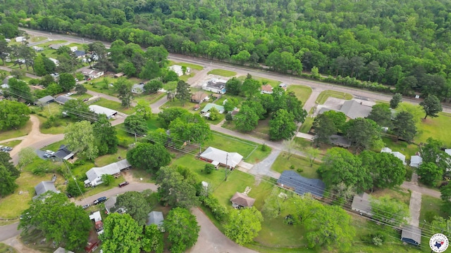 drone / aerial view featuring a view of trees and a residential view