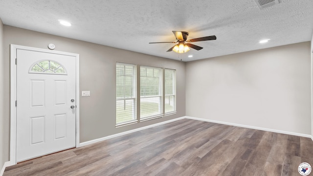2401 E E Ave B, Hooks, TX 75561 - foyer entrance with ceiling fan, a textured ceiling, wood finished floors, baseboards, and recessed lighting