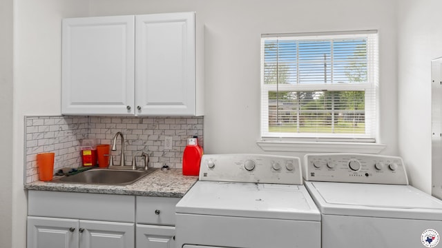 2401 E E Ave B, Hooks, TX 75561 - washroom with cabinet space, washing machine and dryer, and healthy amount of natural light