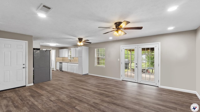 2401 E E Ave B, Hooks, TX 75561 - unfurnished living room featuring dark wood-style floors, a ceiling fan, baseboards, recessed lighting, and french doors