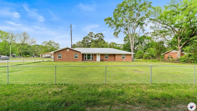 ranch-style home featuring a fenced backyard, brick siding, and a front yard