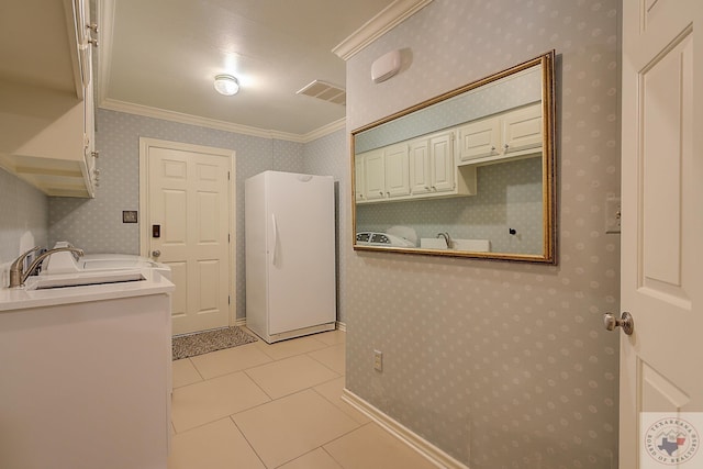 washroom featuring crown molding, sink, and light tile patterned floors