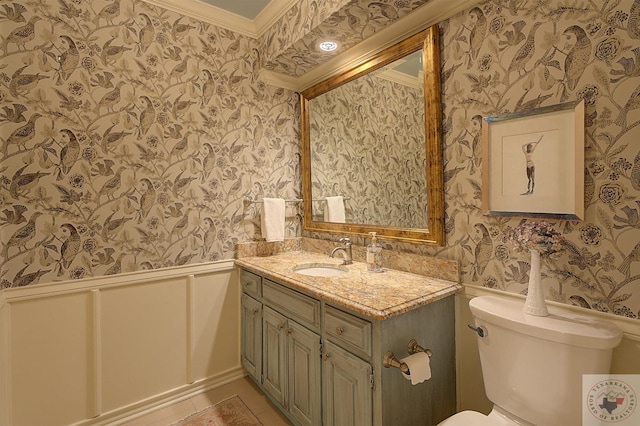 bathroom with crown molding, vanity, and toilet