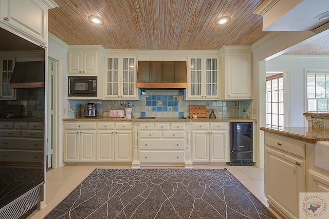 kitchen with light stone counters, wooden ceiling, light tile patterned floors, and black appliances