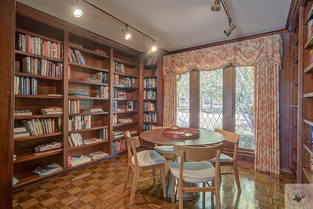 dining area with built in features and dark parquet floors