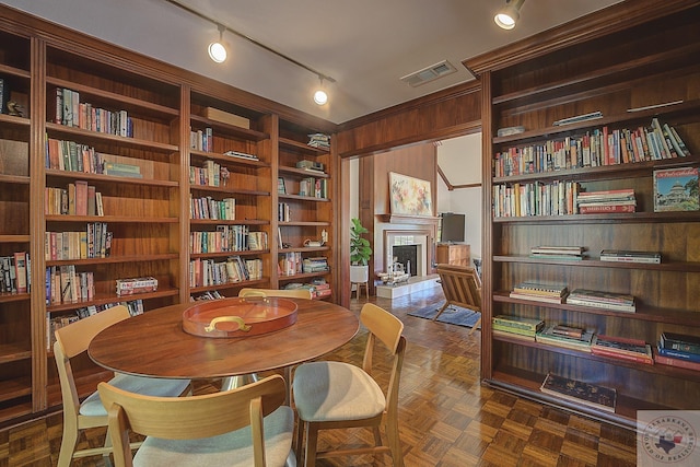 sitting room featuring dark parquet flooring and built in shelves