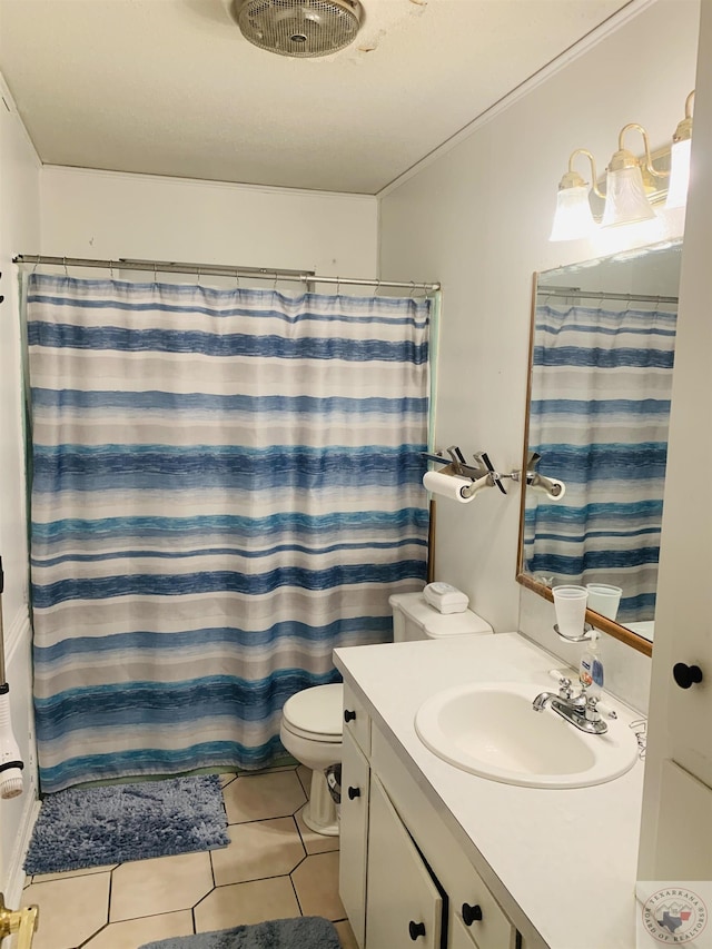 bathroom with curtained shower, toilet, vanity, and tile patterned flooring