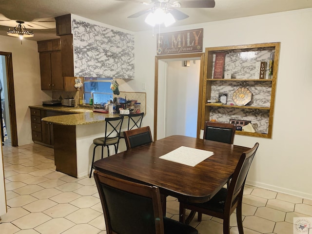 dining space with ceiling fan, sink, and ornamental molding