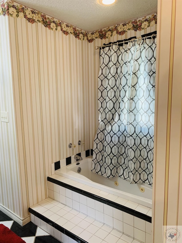 bathroom with a textured ceiling and tiled shower / bath combo