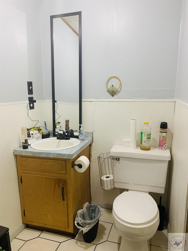 bathroom with toilet, tile patterned floors, and vanity