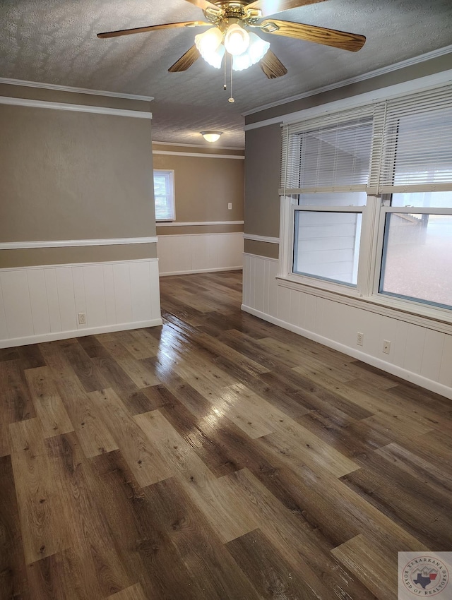 unfurnished room with ceiling fan, crown molding, dark wood-type flooring, and a textured ceiling