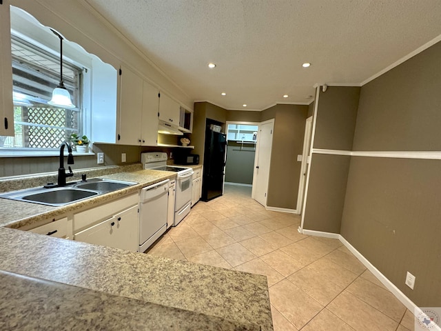 kitchen featuring pendant lighting, sink, white cabinetry, light tile patterned floors, and white appliances