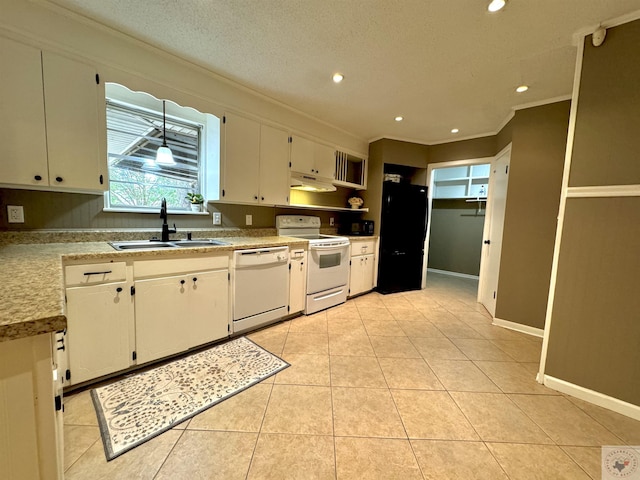 kitchen featuring white appliances, hanging light fixtures, light tile patterned floors, sink, and white cabinets