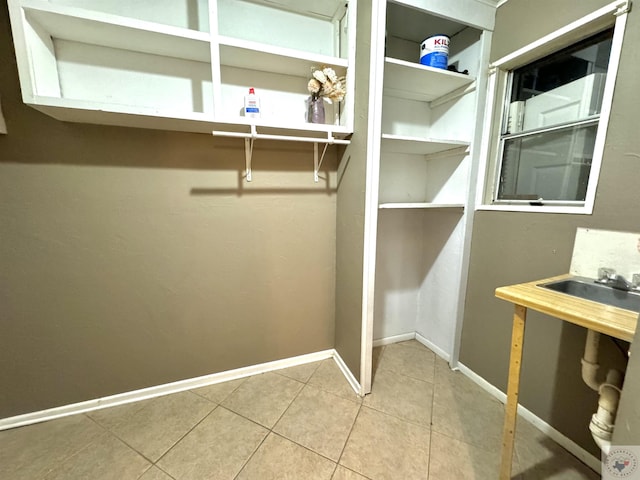 walk in closet with tile patterned floors