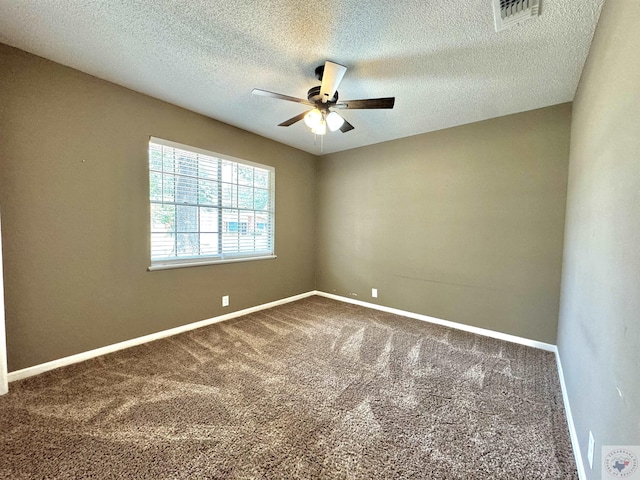 unfurnished room with ceiling fan, carpet flooring, and a textured ceiling