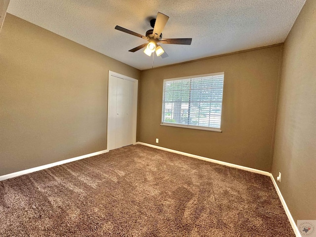 unfurnished bedroom featuring ceiling fan, carpet, a closet, and a textured ceiling