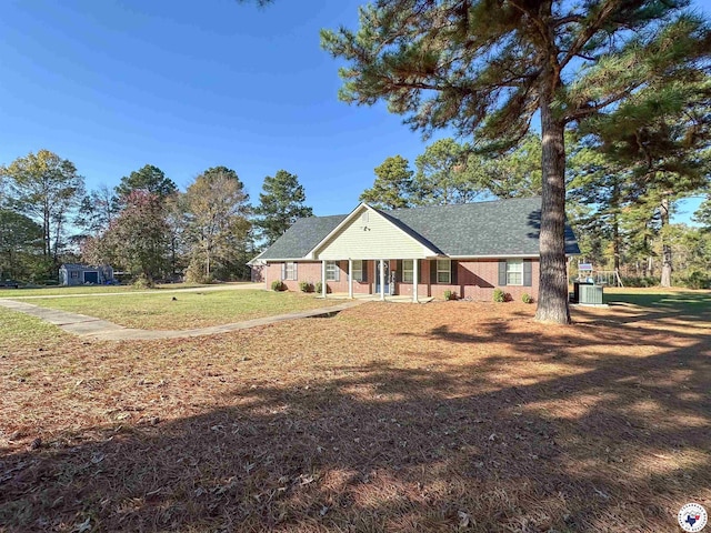 15 Annadale Dr, Maud, TX 75567 - view of front facade featuring a front yard, a shingled roof, central AC unit, and a porch