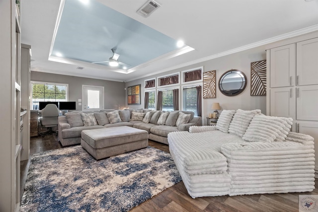 living area with dark wood-style floors, a raised ceiling, and visible vents