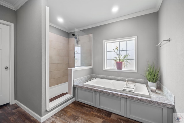 bathroom featuring ornamental molding, a tile shower, a bath, and wood finished floors