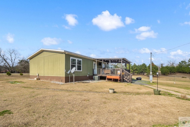 exterior space featuring a deck and a front lawn