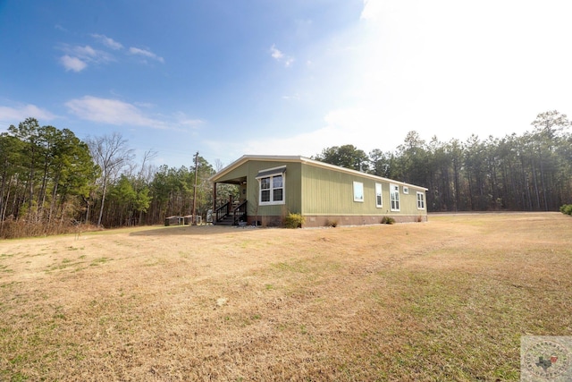 view of side of property with crawl space and a lawn