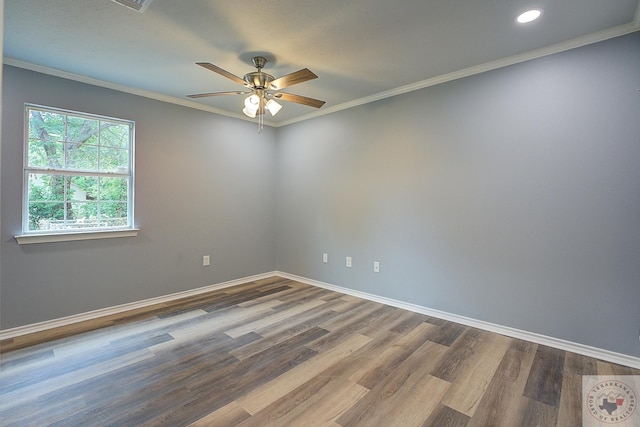 spare room featuring wood-type flooring, ceiling fan, and ornamental molding