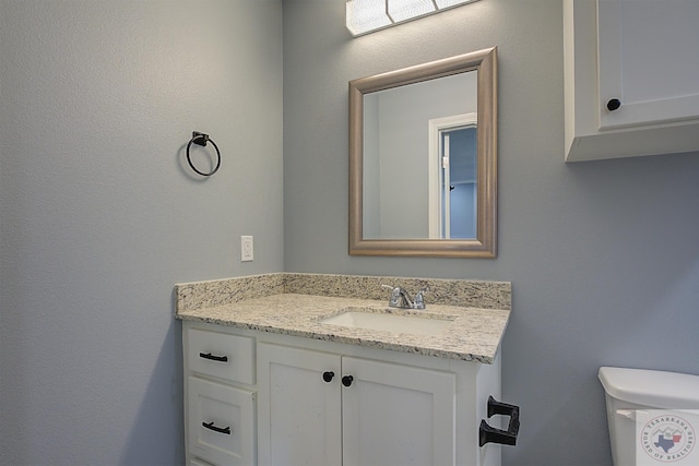 bathroom featuring toilet and vanity